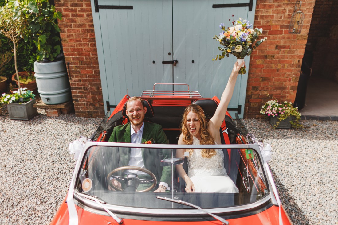 Bride and Groom. Vintage Wedding Car, bridal bouquet 